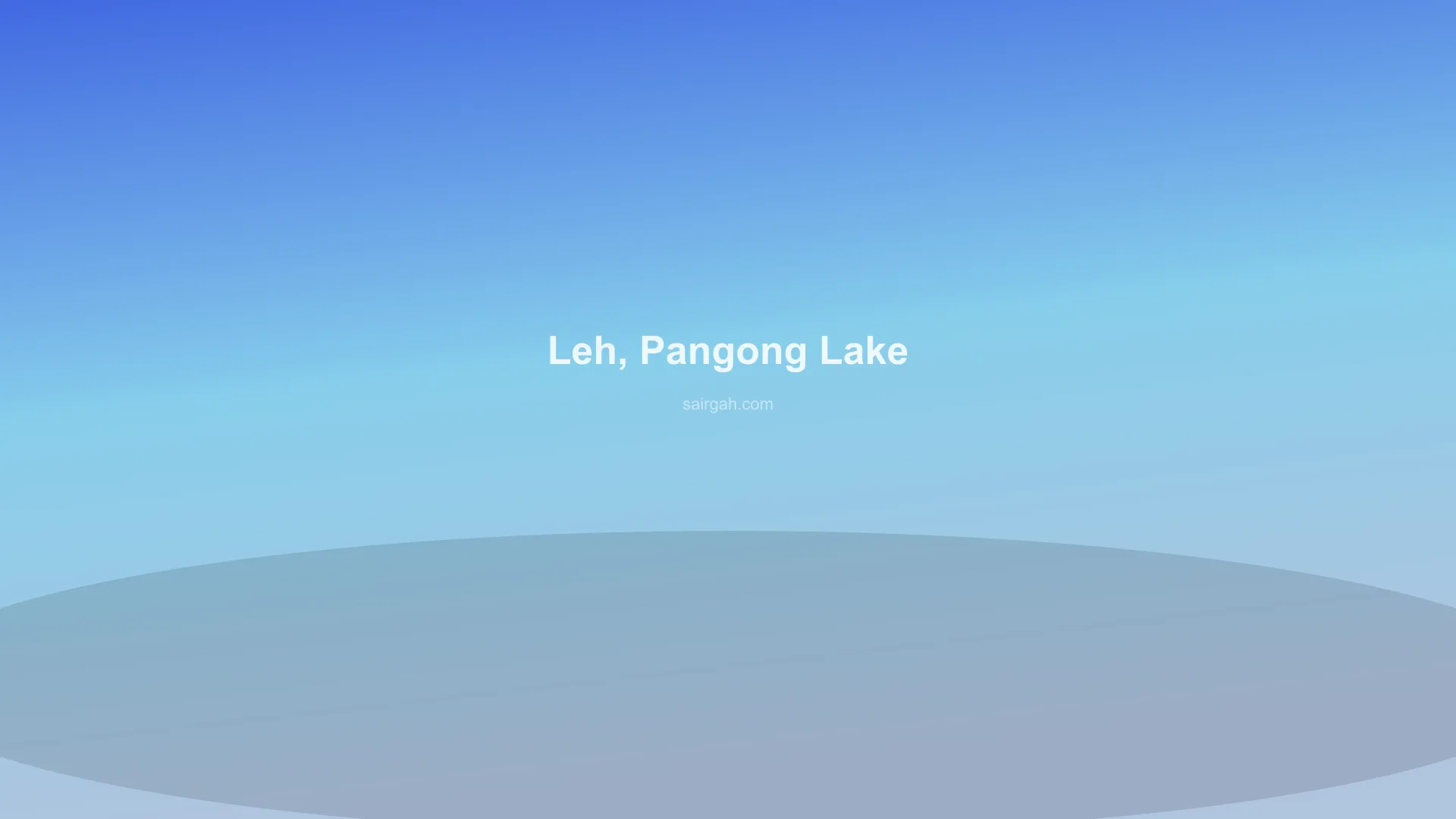 Couple standing by the turquoise waters of Pangong Lake during Sairgah Leh Honeymoon Delight